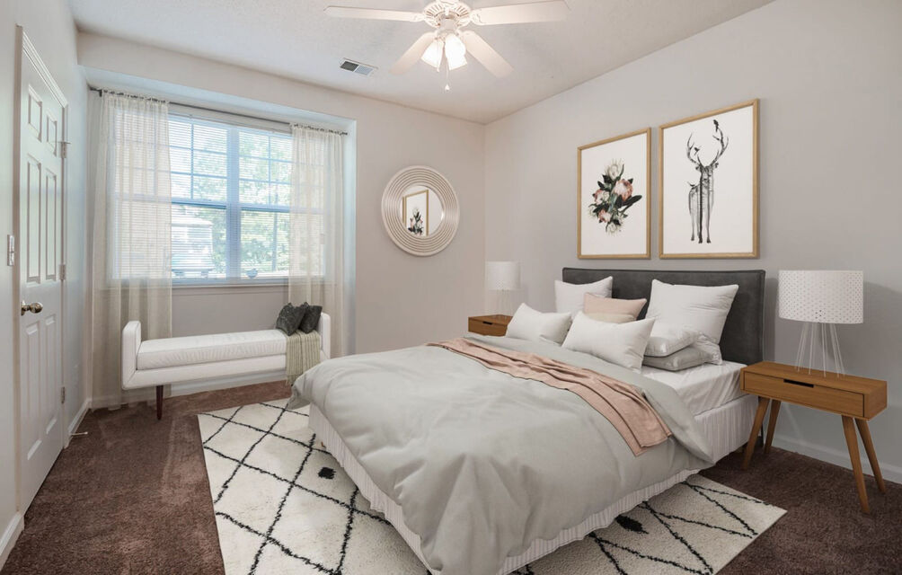 a bedroom with a bed, dresser and a mirror at The Leyland Pointe